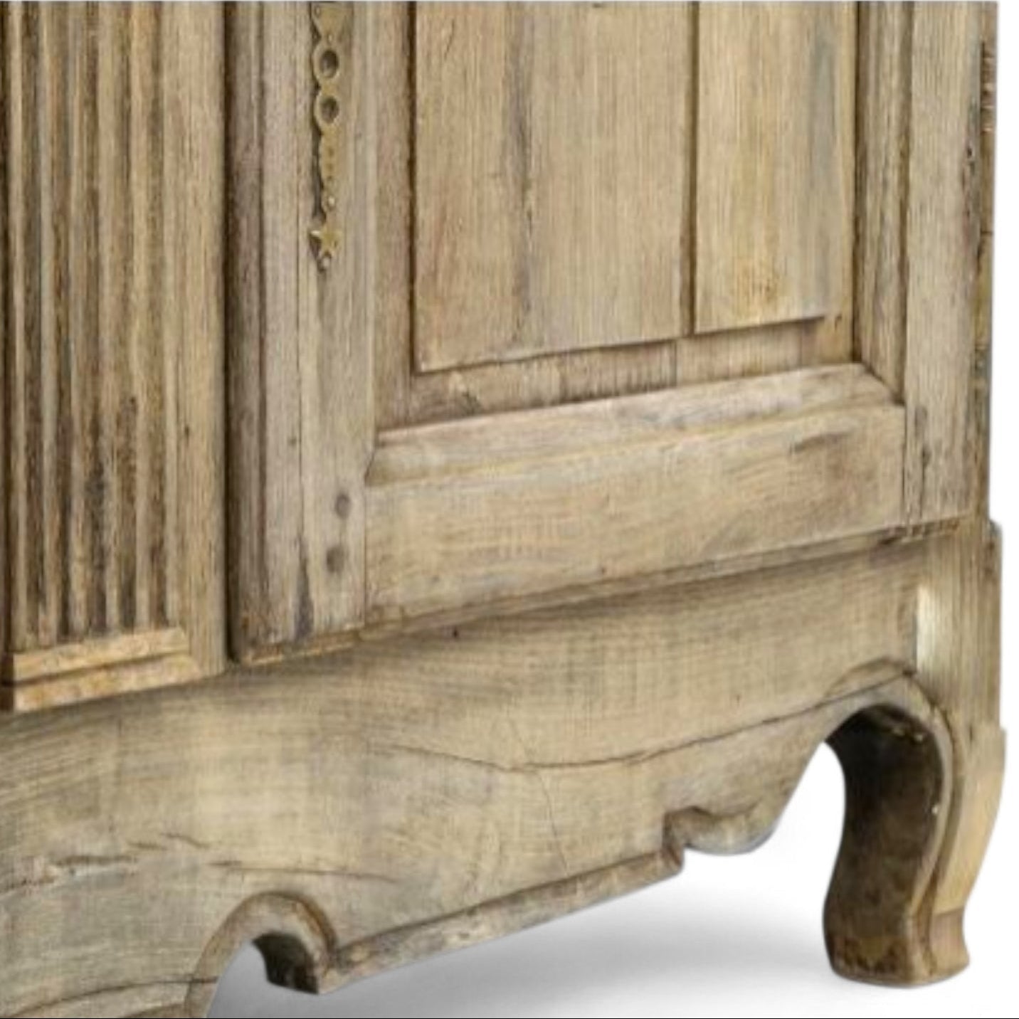 Close-up of a rustic wooden cabinet with detailed carvings on a white background
